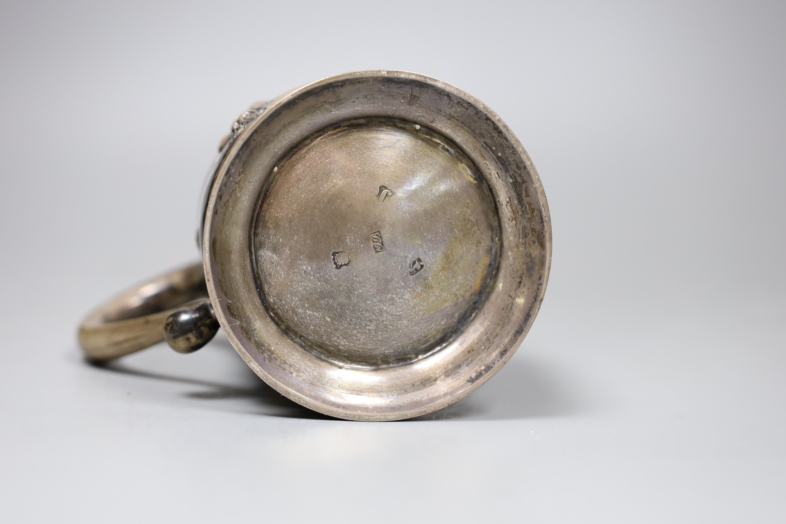 A George III silver pint mug, with later Victorian embossed and chased floral swag decoration and 1862 Agricultural Prize inscription, London 1753, 11 oz.